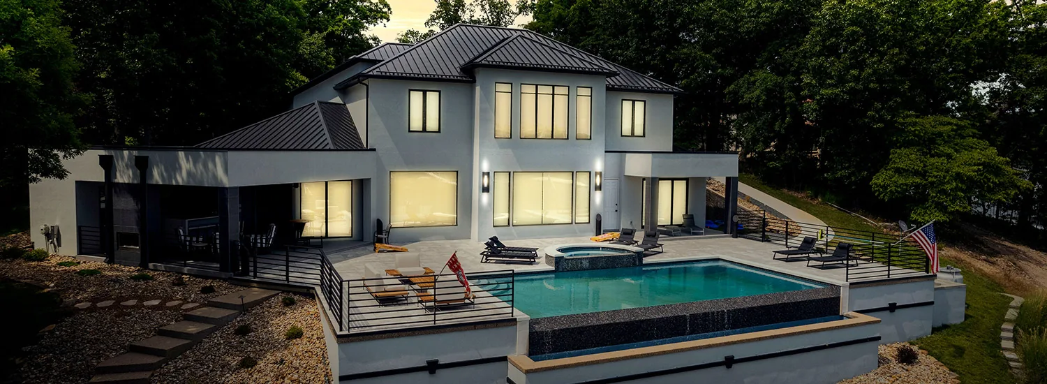Otto Construction modern lakefront custom home with infinity pool at twilight, Lake of the Ozarks